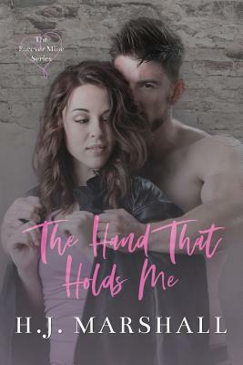 The Hand That Holds Me by H. J. Marshall