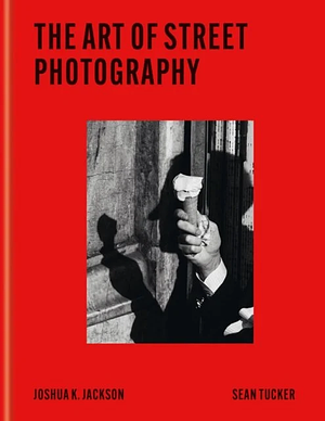 Book cover of 'The Art of Street Photography' by Joshua K. Jackson and Sean Tucker, featuring a striking red background with a black and white photograph of a hand holding a flower.