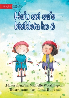 I'll Ride With You (Tetun edition) - Ha'u sei sa'e bisikleta ho ó by Michelle Worthington